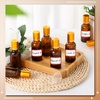 image:imageSumind 24 Sets Clear 30ml Roller Glass Bottle Essential Oil with Stainless Steel Refillable Sample Container Brown Empty Roller Bottle Applicator with Funnel Sticker for TravelGold